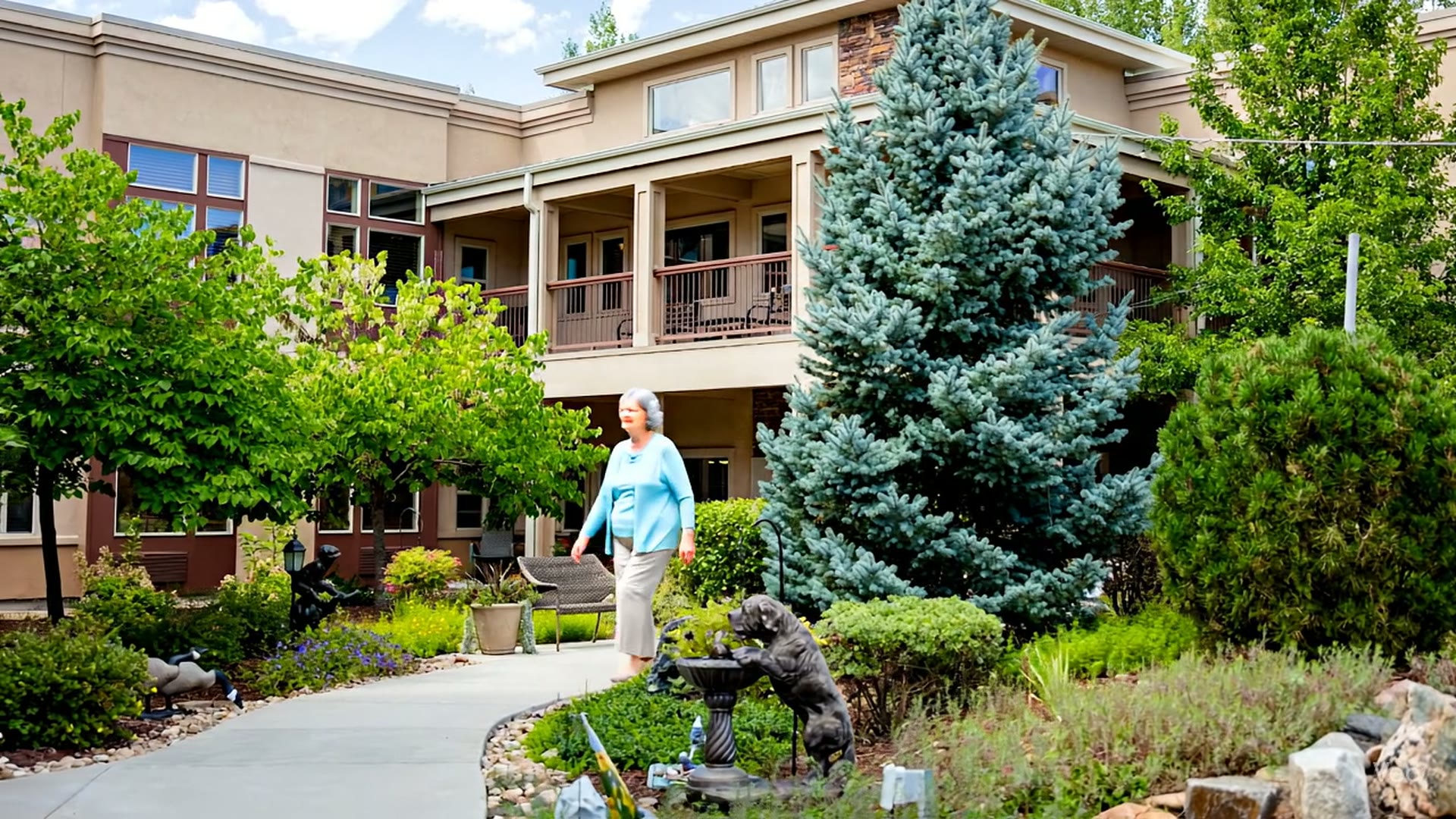 Resident walking through a landscaped courtyard at Gardens on Quail