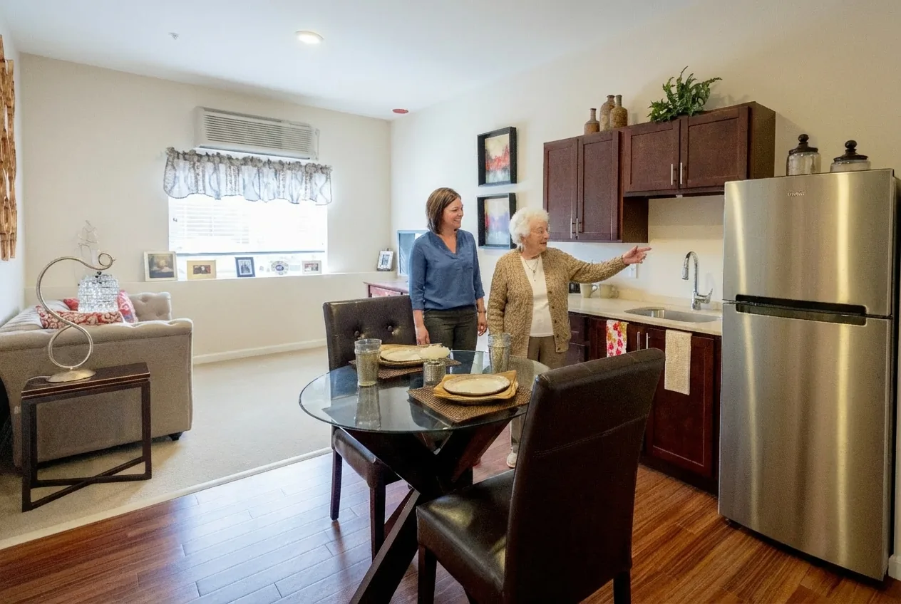 Resident and team member in a Stonebridge Senior apartment kitchen